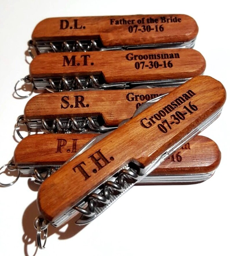 May include: Five wooden handled pocket knives with engraved initials and dates. The knives have a silver blade and a corkscrew.