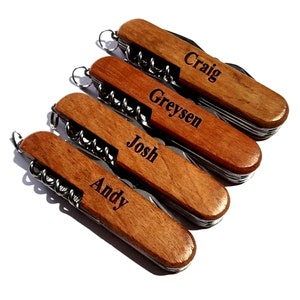 May include: Five wooden handled pocket knives with personalized names: Craig, Greysen, Josh, and Andy.