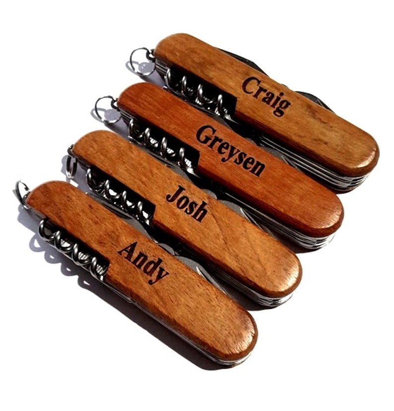 May include: Five wooden handled pocket knives with personalized names: Craig, Greysen, Josh, and Andy.