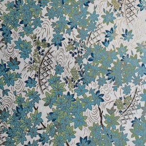 May include: A white background with a repeating pattern of blue and green flowers and a silver lattice design.