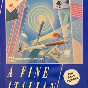 May include: A blue book cover with the title "A Fine Italian Hand" and the author "Eric Wright". The cover features a stylized illustration of playing cards, a pen, and a newspaper clipping.