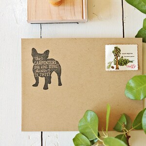 May include: A brown paper envelope with a black rubber stamp of a dog silhouette. The stamp reads "the CARPENTERS 1846 KING STREET Austin TX 78717". A postage stamp with a picture of a giant sequoia tree is on the upper right corner of the envelope.