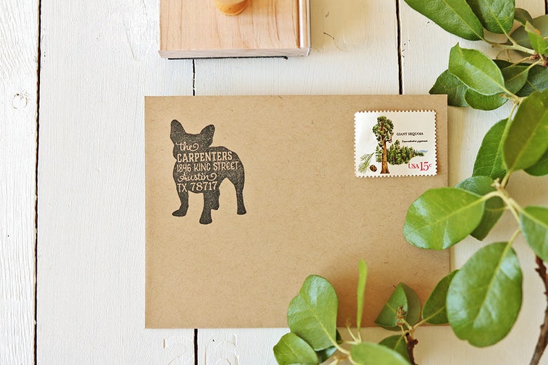 May include: A brown paper envelope with a black rubber stamp of a dog silhouette. The stamp reads "the CARPENTERS 1846 KING STREET Austin TX 78717". A postage stamp with a picture of a giant sequoia tree is on the upper right corner of the envelope.