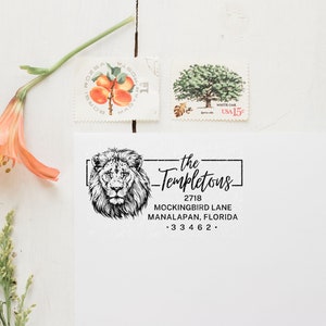 a stamp with a lion on it next to a flower