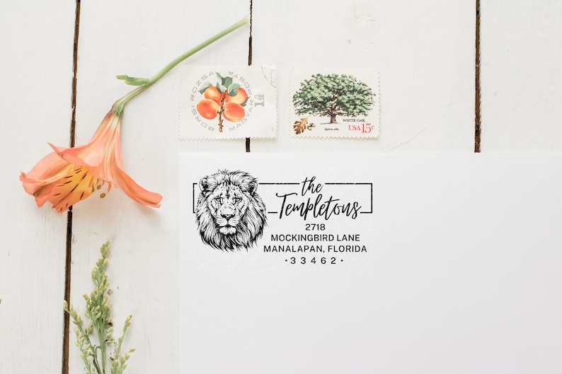 a stamp with a lion on it next to a flower