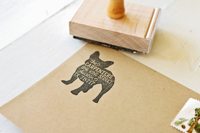 May include: A brown paper envelope with a black silhouette of a French bulldog and the text "the CARPENTERS 1846 KING STREET AUSTIN TX 78717" printed on it.