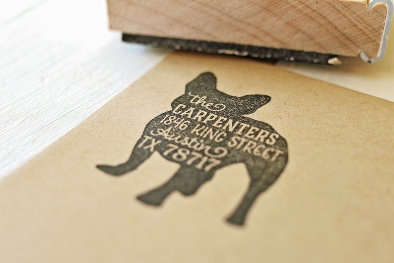 May include: A black silhouette of a French bulldog with the text "the CARPENTERS 1846 KING STREET Austin TX 78717" printed on it.