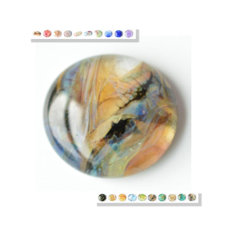 May include: A round, multi-colored glass bead with swirls of white, blue, black, and orange. The bead has a glossy finish.