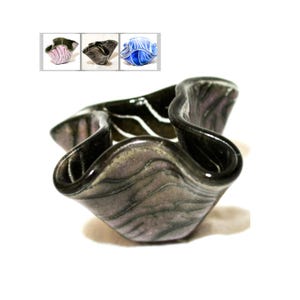 May include: A black and white ceramic bowl with a wavy, organic shape. The bowl has a glossy finish and a subtle purple hue.