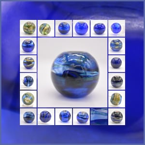 May include: A collection of 25 blue glass beads with gold and silver flecks. The beads are arranged in a grid pattern with a larger bead in the center.