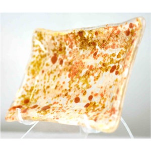 May include: A rectangular glass dish with a speckled pattern of orange, brown, and gold. The dish is made of clear glass with a slightly frosted finish.