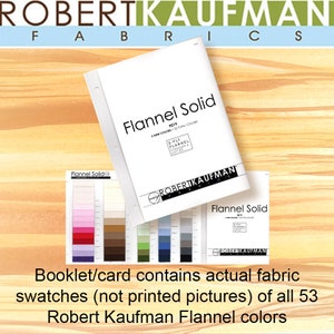 May include: A booklet with the text "Flannel Solid" and "Robert Kaufman Fabrics" on the cover. The booklet contains 53 fabric swatches of different colors. The text "Booklet/card contains actual fabric swatches (not printed pictures) of all 53 Robert Kaufman Flannel colors" is printed below the booklet.