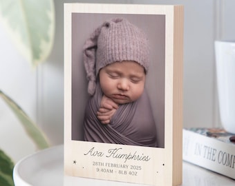 May include: A wooden block photo frame featuring a newborn baby wrapped in a gray blanket and wearing a matching hat. The frame includes the baby's name, birth date, time, and weight: 8lb 4oz.