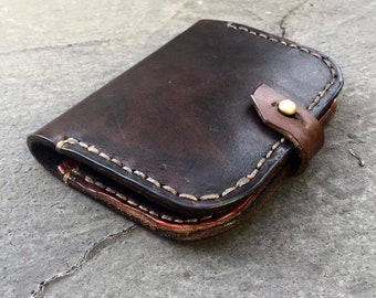 Heavy leather wallet with brass cufflink closure, perfect for riding a motorbike, rugged style