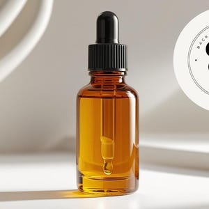 May include: Amber glass bottle with a black dropper filled with a golden liquid. The bottle is labeled with the text "BACK TO BASICS OILS" in a circular logo. The background is a minimalist white design.