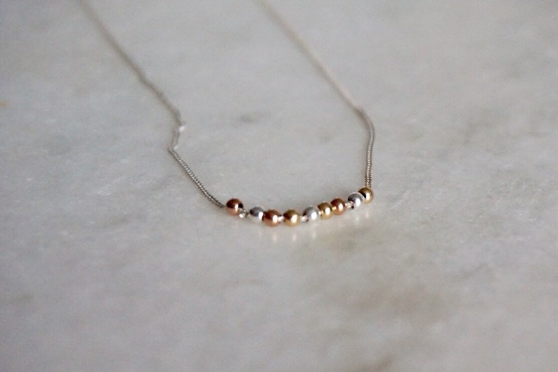 by STICKTAILS MODERATE necklace in sterling and gold filled