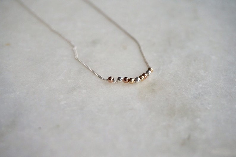 by STICKTAILS MODERATE necklace in sterling and gold filled