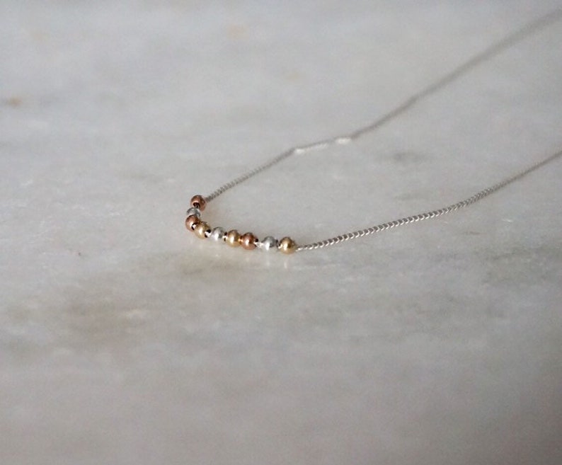by STICKTAILS MODERATE necklace in sterling and gold filled