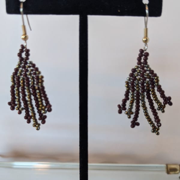 Deep purple and bronze playful dangle earrings are a modest length and width. Prisoner made with quality glass beads.