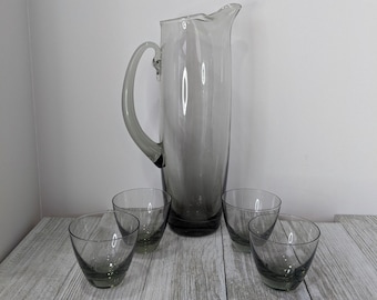Sleek, smokey grey-green & elegant...this mouth blown pitcher with applied handle and four delicate glasses from the 60s are exquisite.