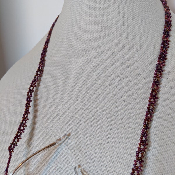 A lacy ladder of coral and purple iridescent glass beads make this prisoner made eyeglass chain or necklace dance.