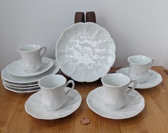 Four child sized Cups (2.5" tall) & Saucers (4.75" wide) and 5 Luncheon Plates (6" wide) pretty, flourished and scalloped edges in white.