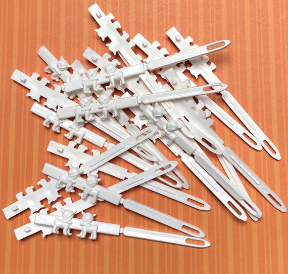 20 white straight barrettes with teeth. Gem