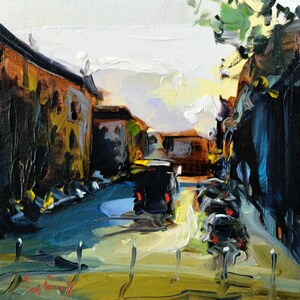 May include: A painting of a city street scene with buildings on either side of the street. The street is paved and there are cars parked on the side of the street. The sky is a light blue color and there are clouds in the sky.