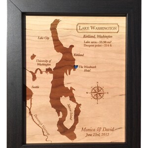 May include: A wooden map of Lake Washington, Kirkland, Washington, with a blue pin marking the location of The Woodmark Hotel. The map includes the text "Lake Washington, Kirkland, Washington, Lake area - 33.98 mi&sup2;, Deepest point - 214 ft" and "Monica & David, June 23rd, 2012".