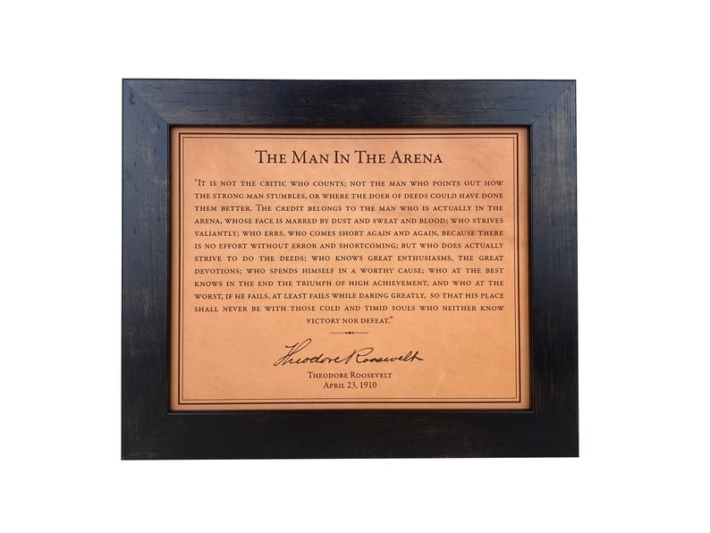 Theodore Roosevelts Man in the Arena quote laser-engraved on high-quality leather, designed as a premium luxury gift. Framed in a rich dark walnut frame, it  includes Theodore Roosevelts signature, making it a distinctive leather graduation gift.