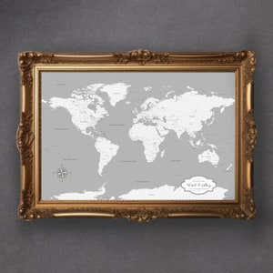 May include: A gray world map in a gold ornate frame. The map is ready to be marked with push pins to track travel destinations. The text "Dale & Shay" is in a decorative frame in the lower right corner of the map.