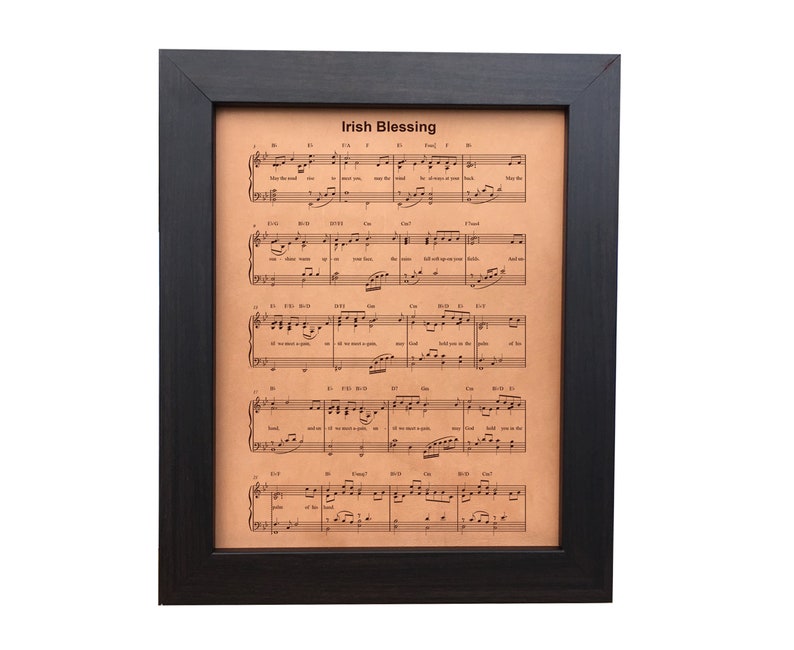 A framed, leather-engraved sheet music displaying the beloved Irish Blessing. Personalization option includes the couple's first names and wedding date, set in a dark walnut frame.