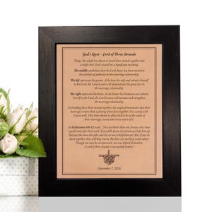 May include: A brown leather plaque with a black frame, featuring a quote about the "Cord of Three Strands" in a marriage. The quote is from Ecclesiastes 4:9-12 and includes a knot illustration. The date September 7, 2024 is printed at the bottom.