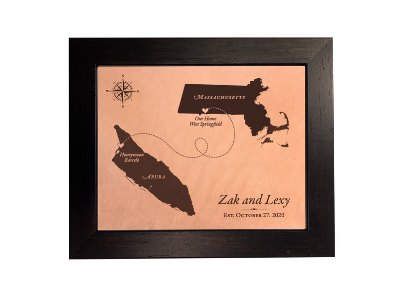A leather anniversary gift and keepsake. Unique leather map art that shows the  honeymoon destination and wedding location. Each map is custom and personalized per your order requests. This sample design shows the travel between wedding venue location and honeymoon in Aruba. Personalized with names and wedding date and engraved on real leather.
