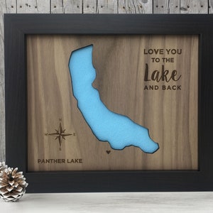 May include: A framed wooden map of Panther Lake with a blue lake cutout and the text "Love you to the Lake and back".