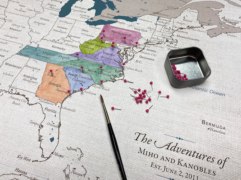 A do it yourself watercolor push pin travel map is printed on 100 percent cotton canvas with a neutral and natural cotton finish. Paint in the states visited and pin the exact cities for a unique travel keepsake. Personalized with names and date.