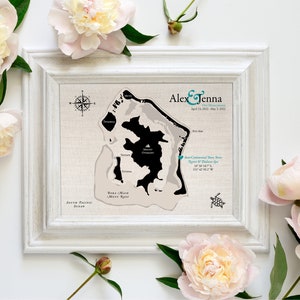 Custom cotton keepsake map of Bora Bora is printed on all natural cotton for a unique anniversary gift. Framed in a white frame and sitting with pink roses, this bespoke map is made to your specifications.