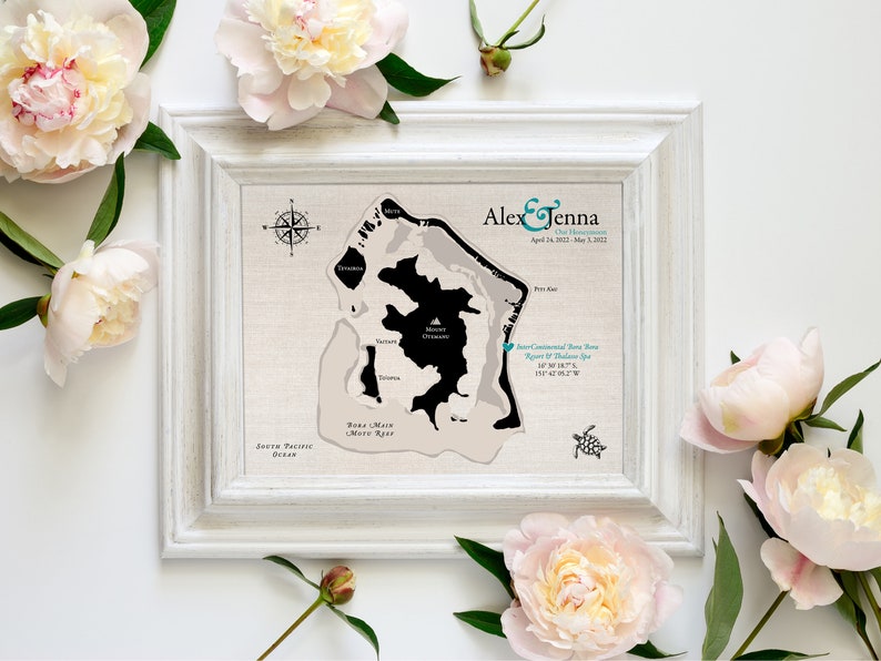 Custom cotton keepsake map of Bora Bora is printed on all natural cotton for a unique anniversary gift. Framed in a white frame and sitting with pink roses, this bespoke map is made to your specifications.