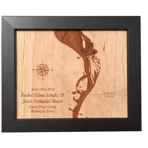 May include: A framed wooden map of Eagle Point Park in Dubuque, Iowa, with the text "June 16th 2012 Rachel Eileen Schultz & Jacob Nathaniel Straub Eagle Point Park Dubuque, Iowa" and "Wisconsin Illinois" engraved on the wood.