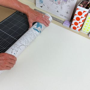 Mike Wilkeson carefully rolls a finished personalized push pin travel map in our Luray, Virginia studio as he prepares it for packaging and shipping. From the original map design and personalization to printing, finishing, and packing, every travel map is thoughtfully made by husband-and-wife team (Mike and Jess) from start to finish.