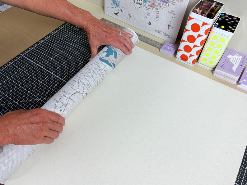 Mike Wilkeson carefully rolls a finished personalized push pin travel map in our Luray, Virginia studio as he prepares it for packaging and shipping. From the original map design and personalization to printing, finishing, and packing, every travel map is thoughtfully made by husband-and-wife team (Mike and Jess) from start to finish.