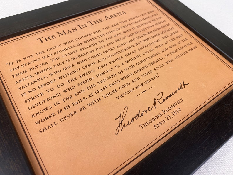 detailed view of the leather framed Man in the Arena engraved quote by Theodore Roosevelt.