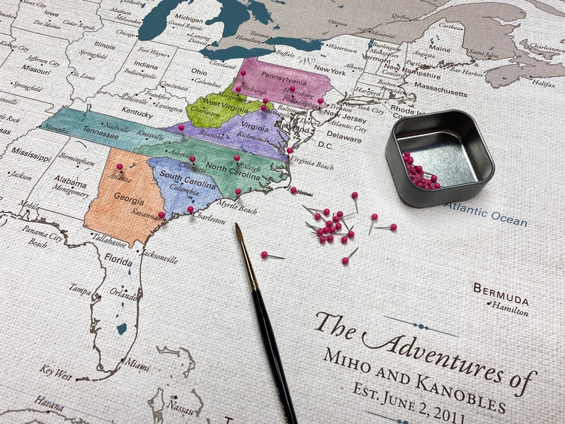 A do it yourself watercolor push pin travel map is printed on 100 percent cotton canvas with a neutral and natural cotton finish. Paint in the states visited and pin the exact cities for a unique travel keepsake. Personalized with names and date.