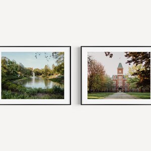 May include: Two framed photographs of a college campus. The first photo shows a pond with a fountain in the background. The second photo shows a brick building with a clock tower.