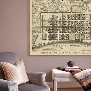 May include: A vintage map of New Orleans, Louisiana, printed on canvas and framed. The map shows the city's layout with streets and buildings, and includes the text "PLAN OF NEW ORLEANS THE CAPITAL OF LOUISIANA".