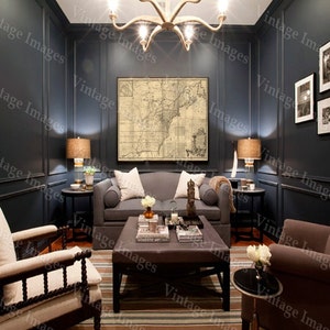 May include: A dark blue living room with a vintage map hanging on the wall, two armchairs, a sofa, a coffee table, and a side table. The room is decorated with a chandelier, lamps, and plants.
