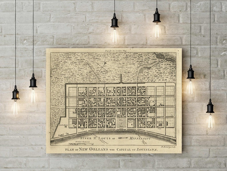 May include: An antique map of New Orleans, Louisiana, showing the city's layout and the Mississippi River. The map is printed in black and white on a beige background. The text on the map reads "PLAN of NEW ORLEANS the CAPITAL of LOUISIANA."