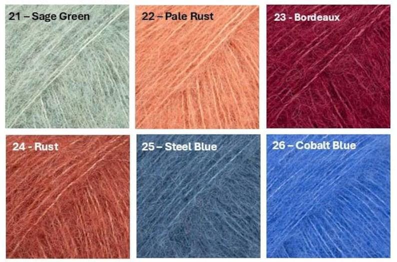 May include: A collection of six yarn samples in various colors. The colors are labeled: Sage Green, Pale Rust, Bordeaux, Rust, Steel Blue, and Cobalt Blue. Each sample is a square of fluffy yarn.