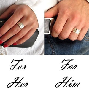 May include: Two silver rings with engraved text. The ring on the left says "For Her" and the ring on the right says "For Him".