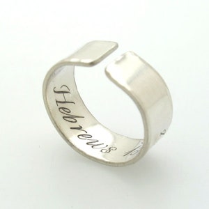 May include: Silver ring with the word "Hebrews" engraved on the inside.